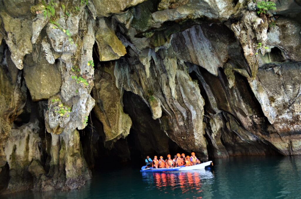 A group of tourists on a boat tour of the Puerto Princesa Subterranean River National Park in Palawan, Philippines.