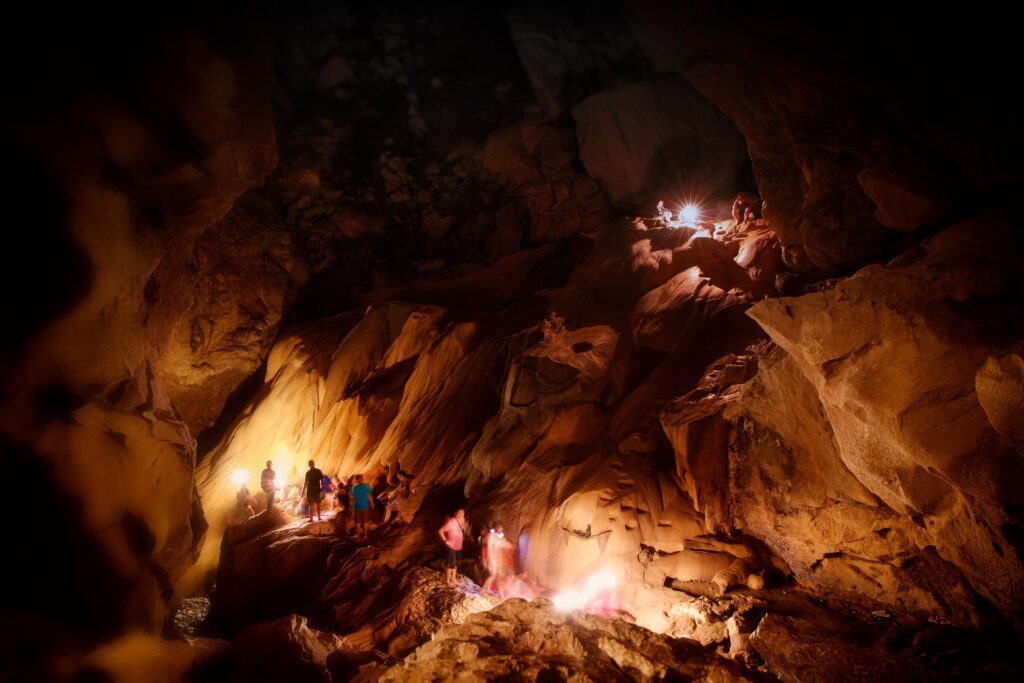 A group of tourists explores Sumaguing Cave in Sagada, Mountain Province, Philippines.